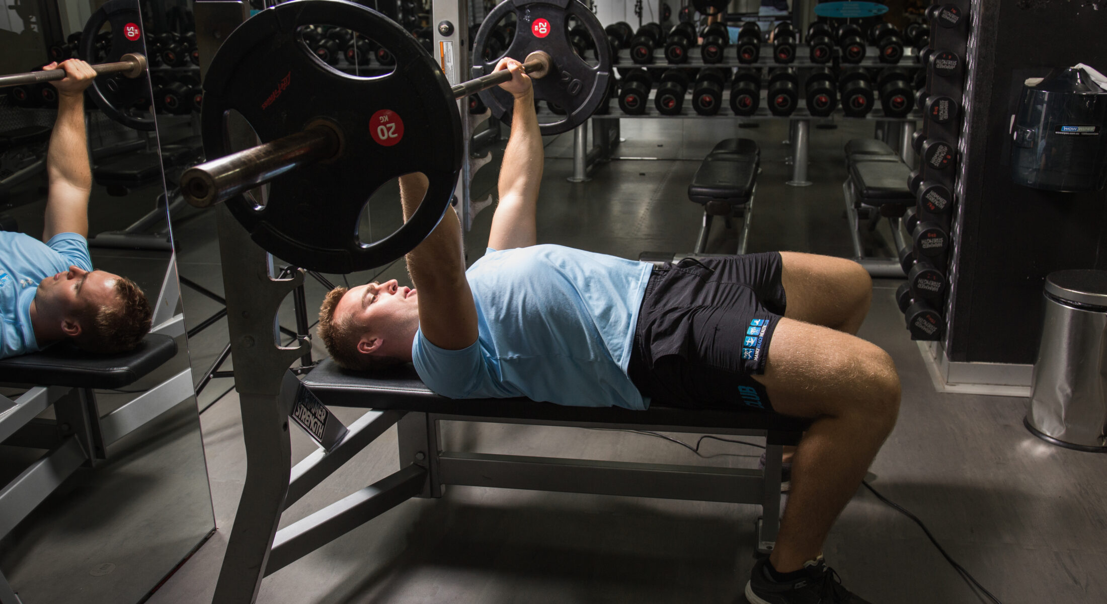 A man bench pressing in a gym